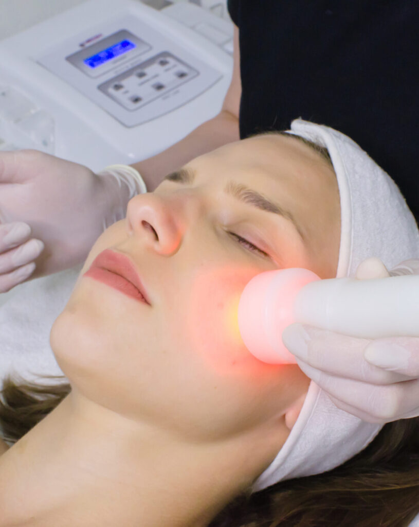 Red light therapy is performed on a female patient for skin pore cleansing for how does light therapy work blog.